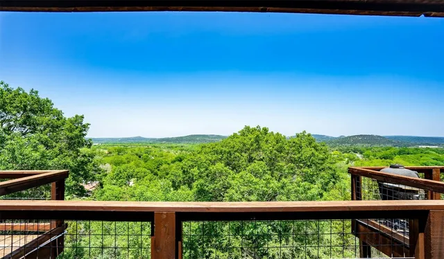 a view of a forest from a balcony