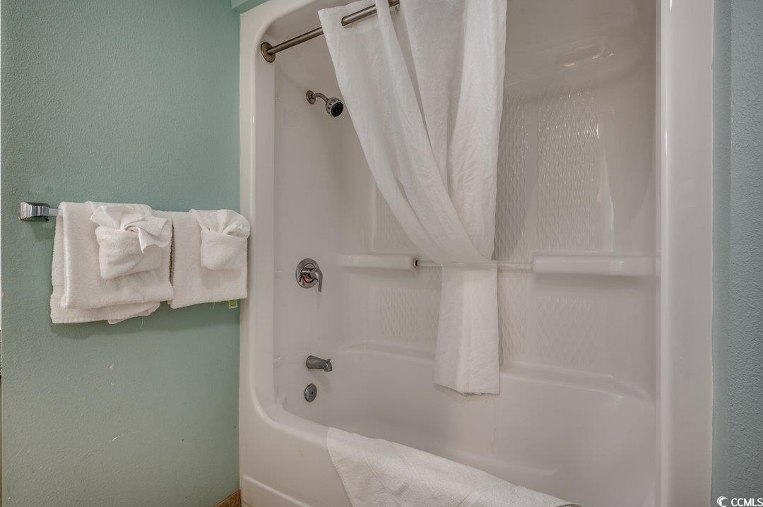 7100 North Ocean Boulevard, Unit 825 Myrtle Beach, SC 29572 - Photo 11 of 38 Bathroom with shower / bath combo with shower curt