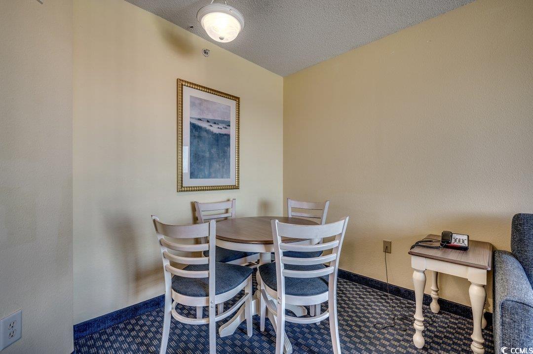 7100 North Ocean Boulevard, Unit 825 Myrtle Beach, SC 29572 - Photo 5 of 38 Dining room featuring a textured ceiling