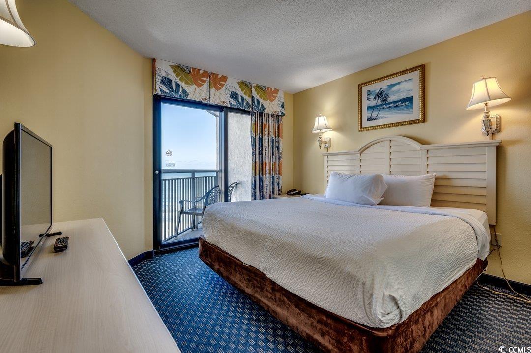 7100 North Ocean Boulevard, Unit 825 Myrtle Beach, SC 29572 - Photo 9 of 38 Carpeted bedroom with access to outside and a text