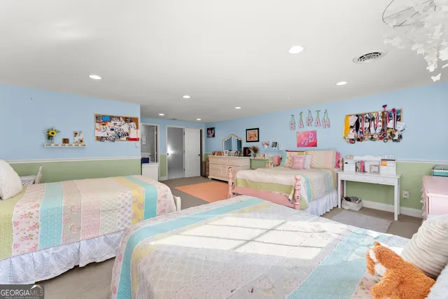 a work room with furniture and a flat screen tv