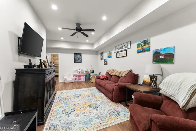 a living room with furniture and a flat screen tv