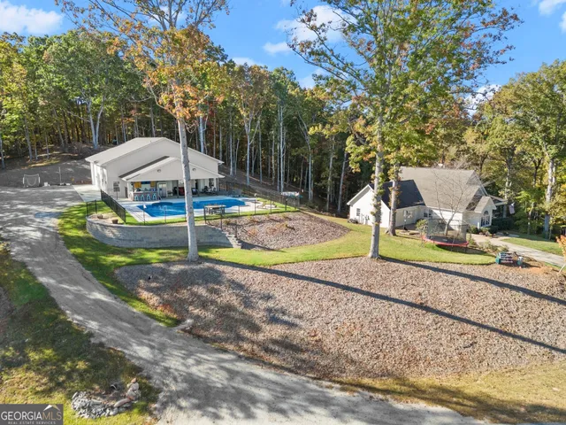 a spacious bathroom with a granite countertop sink a toilet and a mirror