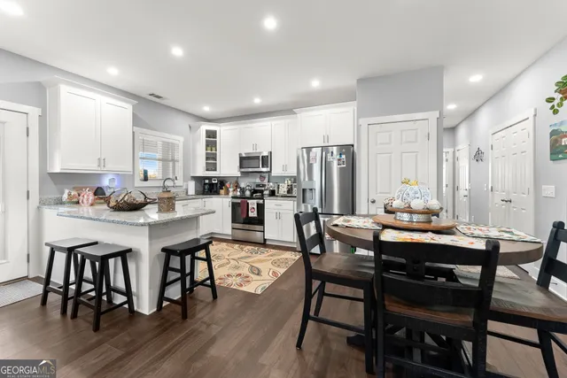 a view of a house with swimming pool and sitting area