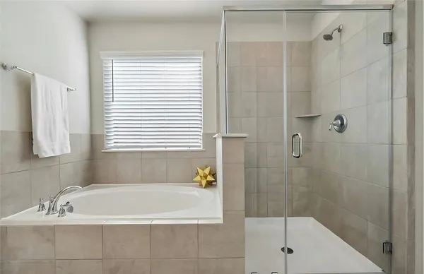 a bath tub sitting next to a shower