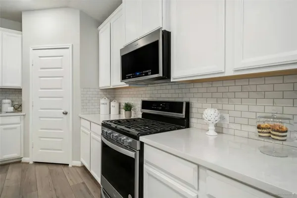 a kitchen with stainless steel appliances a white stove top oven and sink