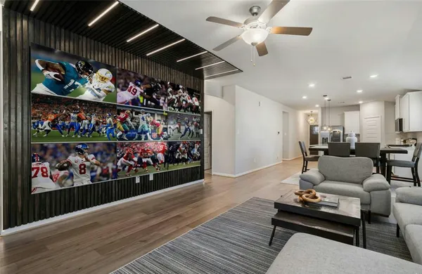 a living room with lots of furniture and a wooden floor