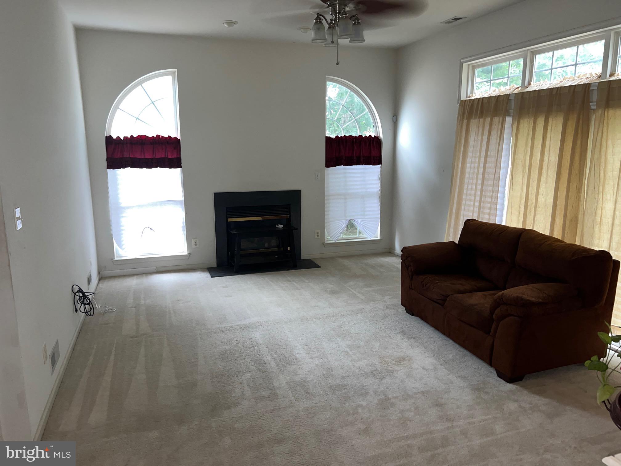 24 Brookstone Drive Sicklerville, NJ 08081 - Photo 8 of 22 a living room with furniture and a large window