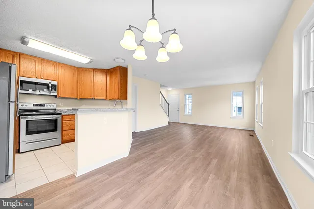 a view of kitchen with stove and microwave