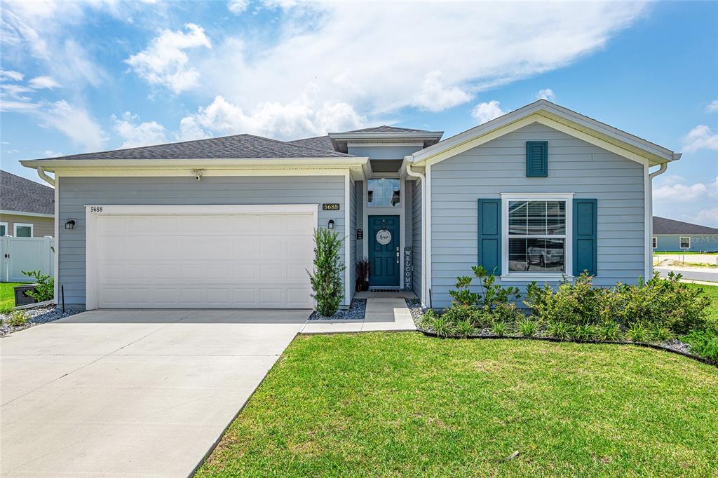 5688 Southwest 92nd Place Ocala, FL 34476 - Photo 1 of 54 a front view of house with yard and green space