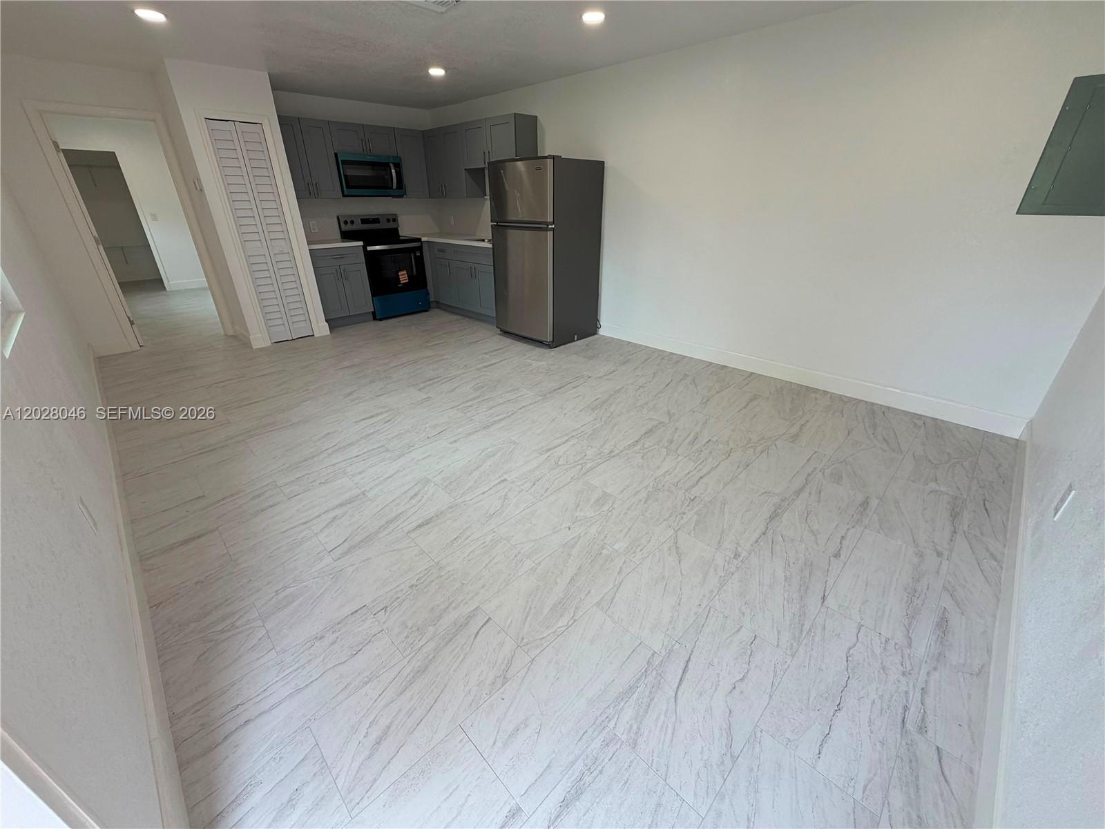 19321 Southwest 196th Street, Unit 1 Miami, FL 33187 - Photo 2 of 10 a view of kitchen with refrigerator and wooden floor