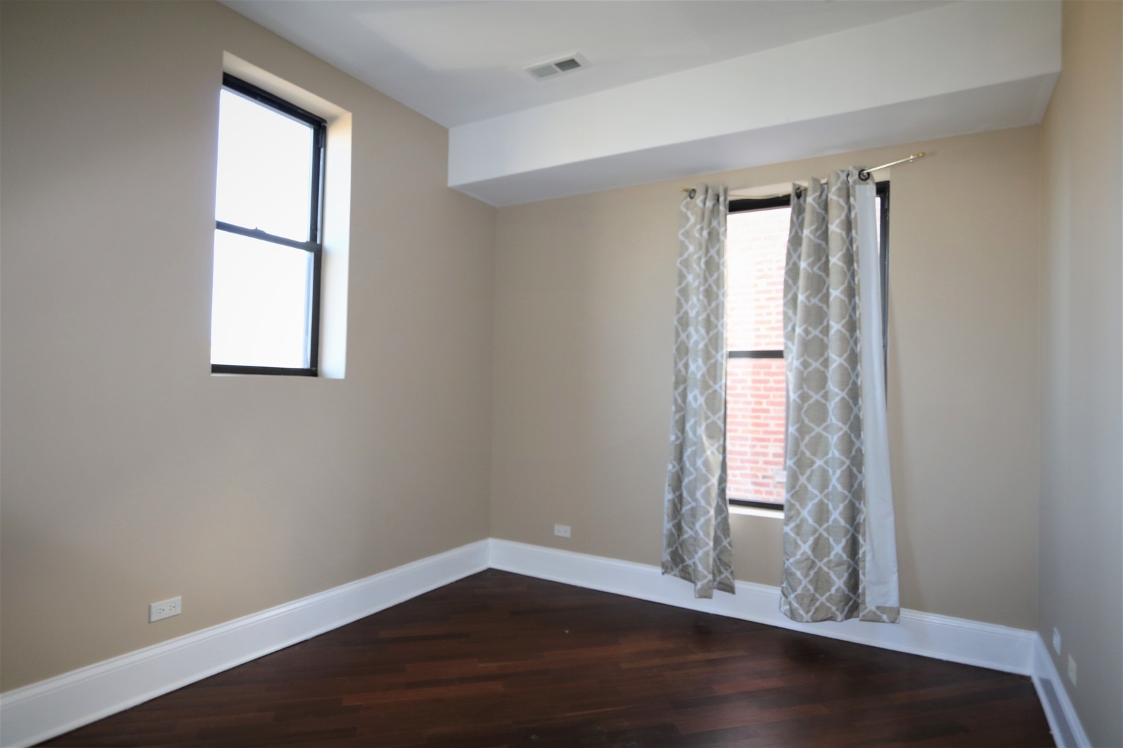 5203 South Indiana Avenue, Unit 3 Chicago, IL 60615 - Photo 13 of 15 an empty room with wooden floor and windows