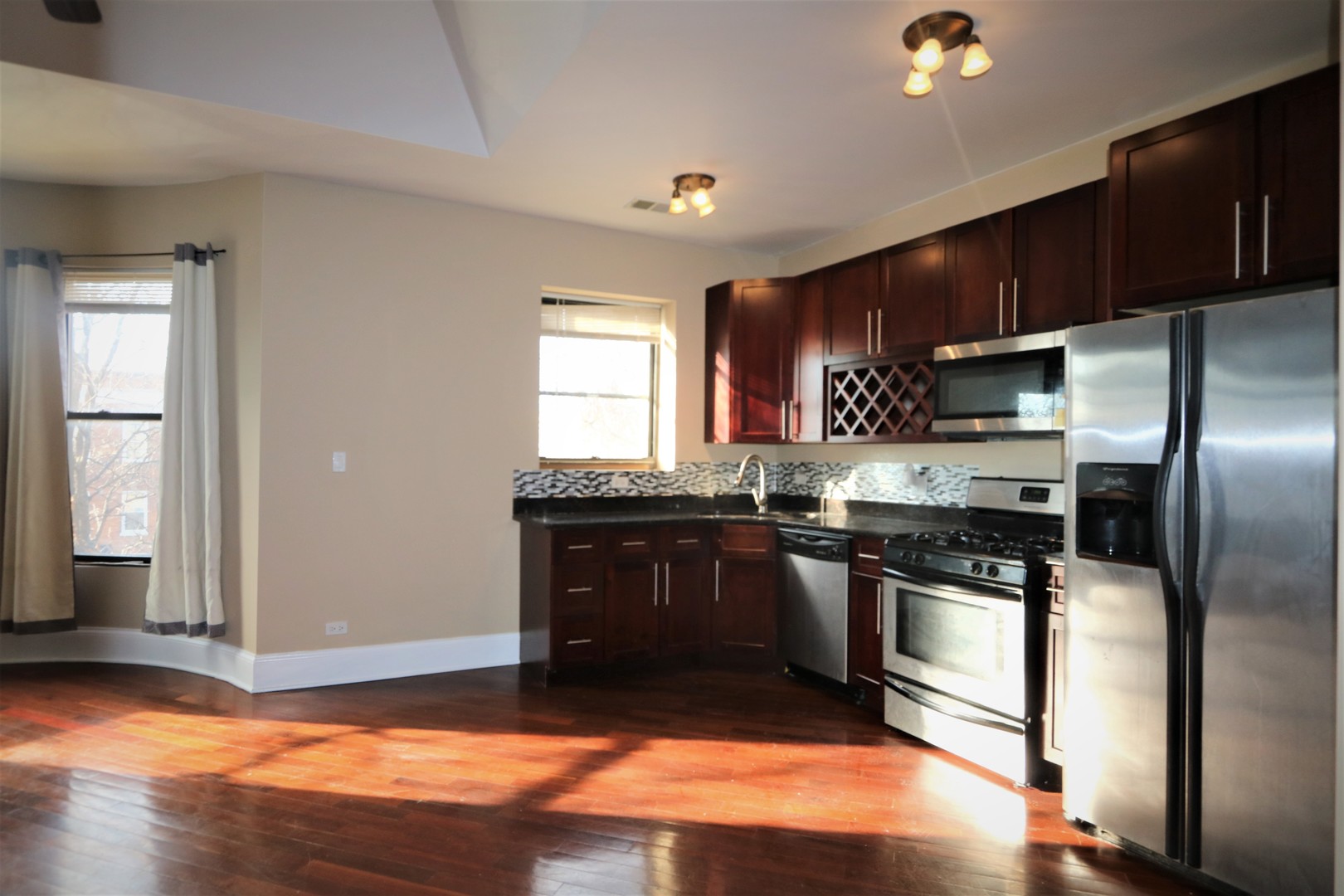 5203 South Indiana Avenue, Unit 3 Chicago, IL 60615 - Photo 5 of 15 a kitchen with stainless steel appliances granite countertop a stove a sink and a refrigerator