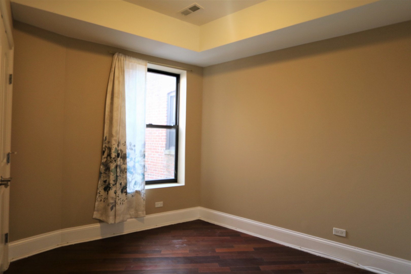5203 South Indiana Avenue, Unit 3 Chicago, IL 60615 - Photo 6 of 15 a view of an empty room with wooden floor and a window