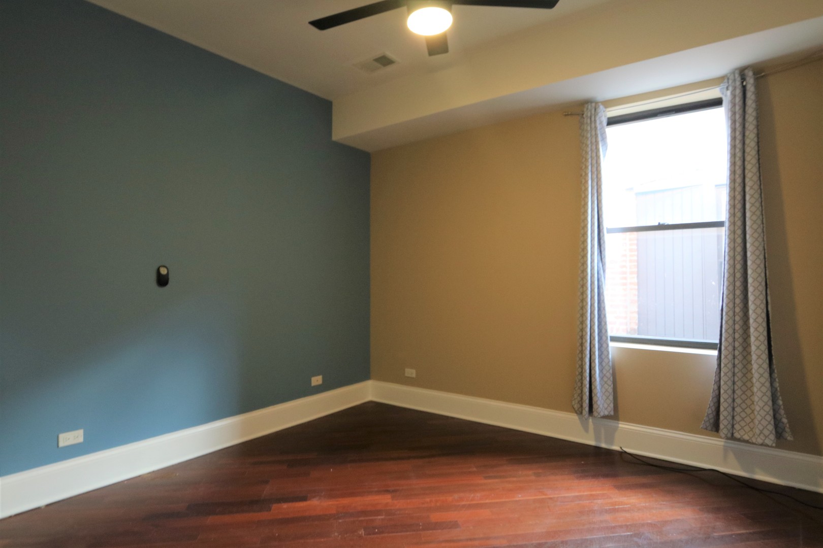 5203 South Indiana Avenue, Unit 3 Chicago, IL 60615 - Photo 9 of 15 an empty room with wooden floor and windows