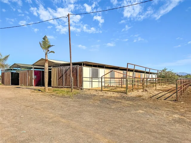 a blue and white umbrella sitting in front of a house