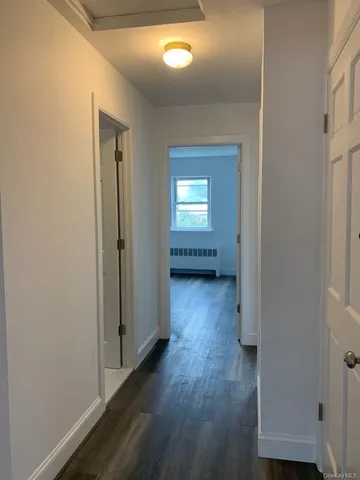 a view of hallway with wooden floor
