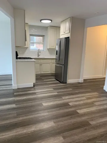 a kitchen with stainless steel appliances granite countertop a refrigerator and a sink