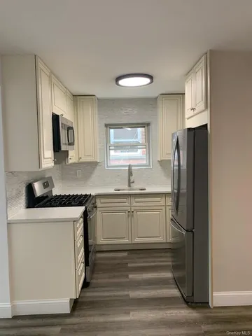 a kitchen with a sink stove and refrigerator