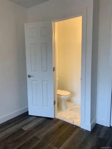 a big room with wooden floor and a door