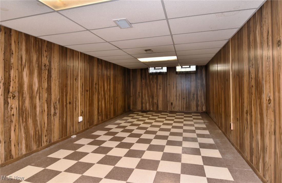 38535 Aurora Road Solon, OH 44139 - Photo 20 of 26 Basement featuring wood walls and a paneled ceiling