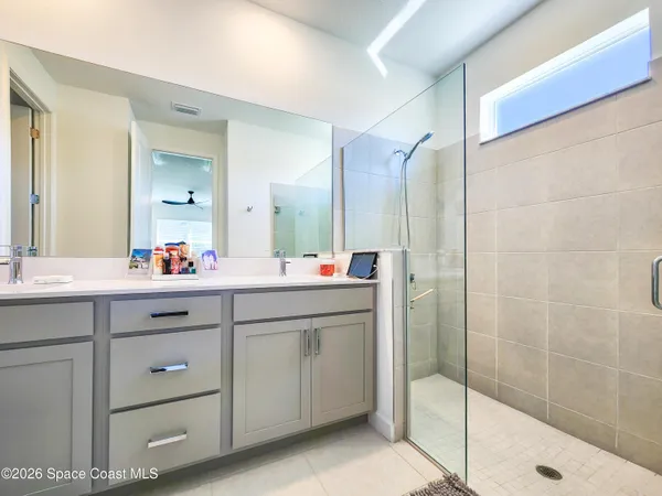 a bathroom with a sink a toilet a tub and shower