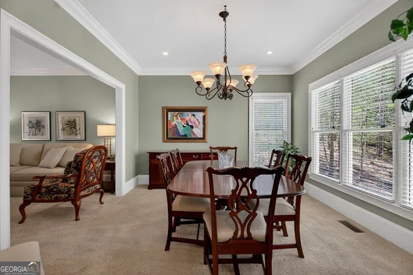 a view of a dining room with furniture and a chandelier