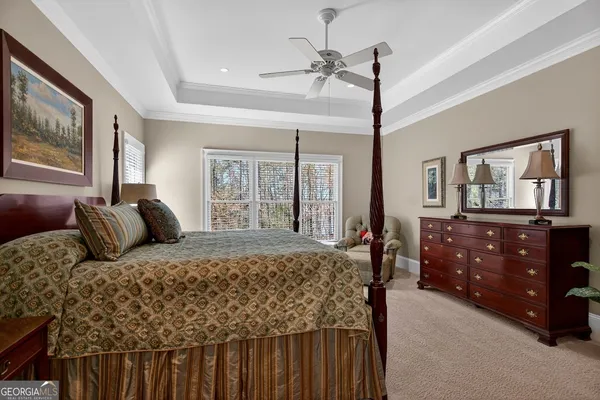 a bedroom with a bed a dresser and next to a window