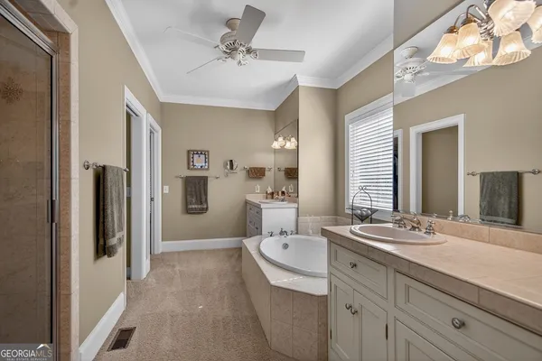 a spacious bathroom with a double vanity sink a mirror and a bathtub