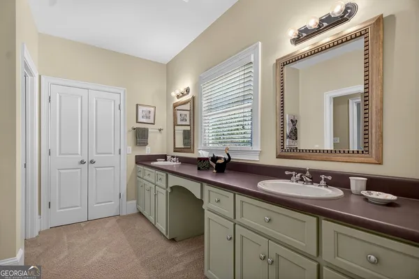 a bathroom with double sink and a mirror