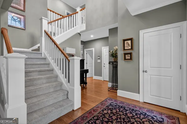 a view of entryway and hall with wooden floor