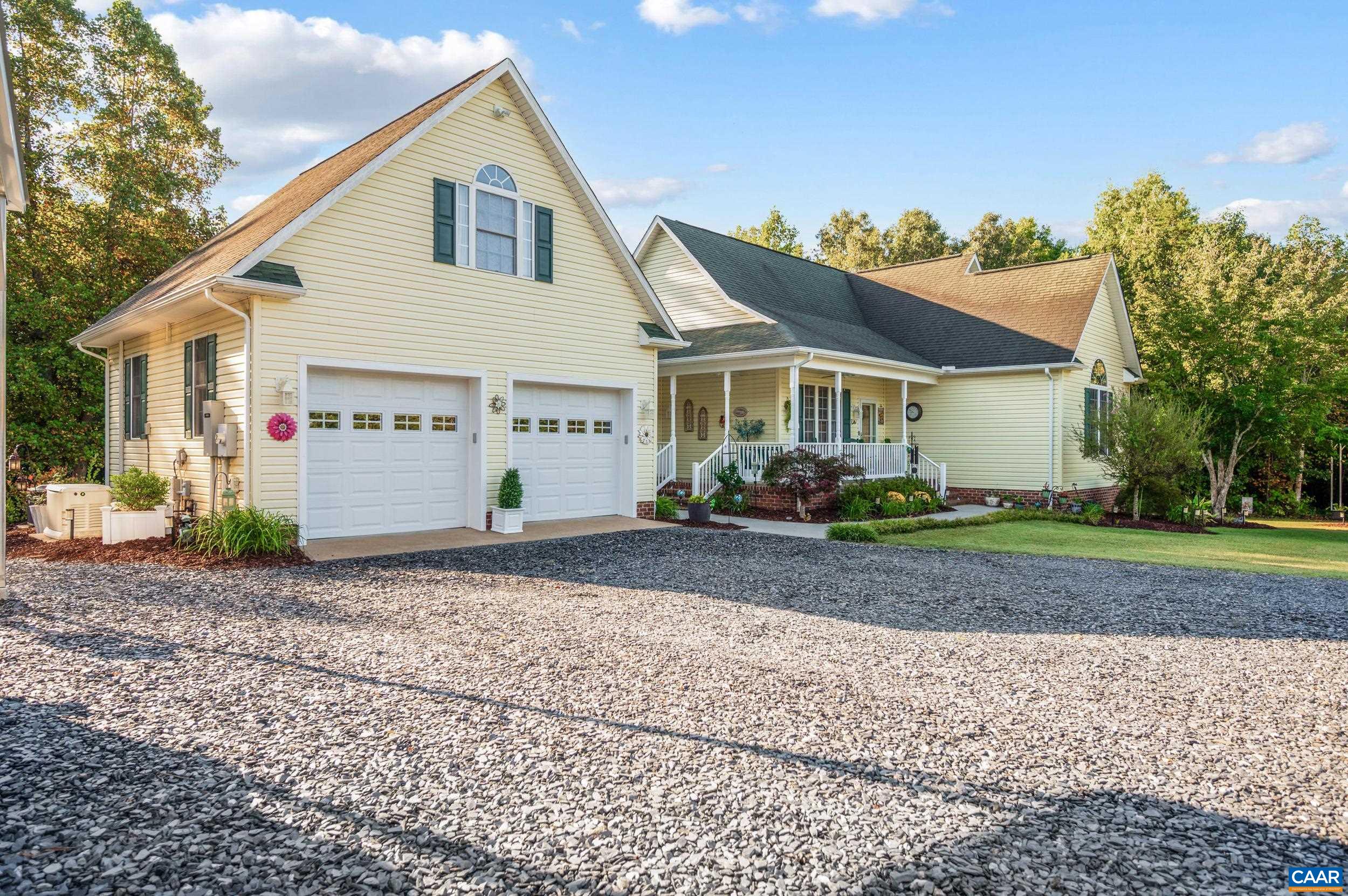 873 Copper Mine Road Dillwyn, VA 23936 - Photo 26 of 49 a view of a white house next to a yard with road and trees