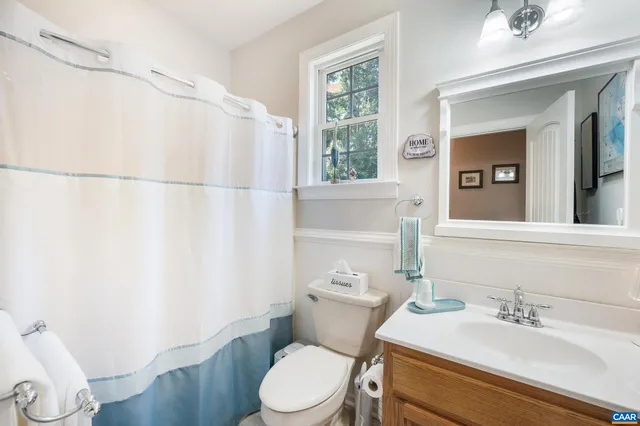 a white toilet sitting next to a bathroom sink