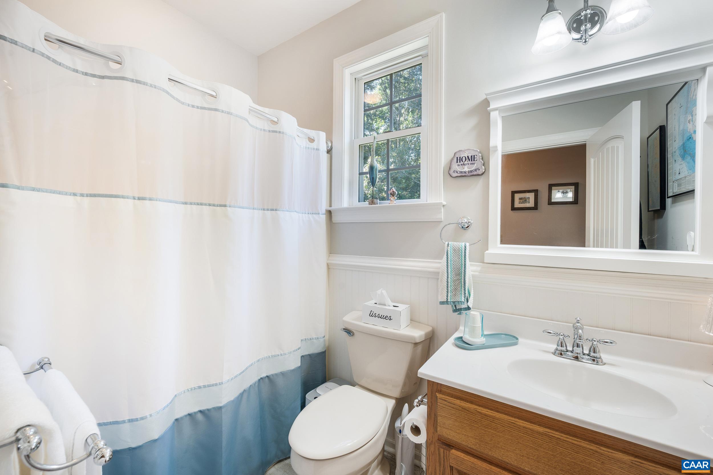 873 Copper Mine Road Dillwyn, VA 23936 - Photo 8 of 49 a white toilet sitting next to a bathroom sink