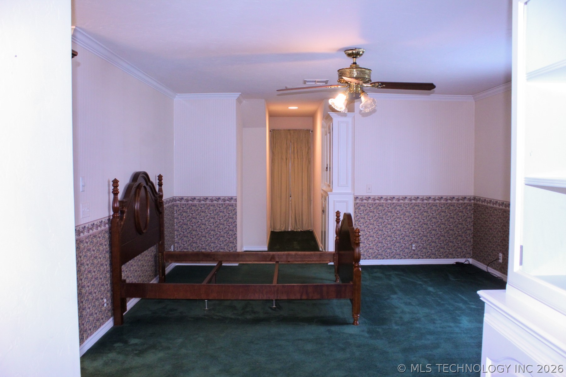 13248 North 3540th Road Maud, OK 74854 - Photo 68 of 98 Room featuring green carpeting, chair rail molding with floral wallpaper, white wall paint, and crown molding