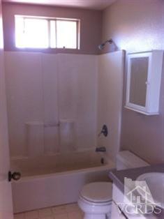 4506 Apricot Road, Unit B Simi Valley, CA 93063 - Photo 11 of 13 a bath room with a toilet a bath tub and a window