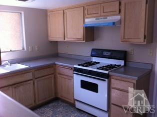 4506 Apricot Road, Unit B Simi Valley, CA 93063 - Photo 5 of 13 a kitchen with granite countertop a stove sink and cabinets