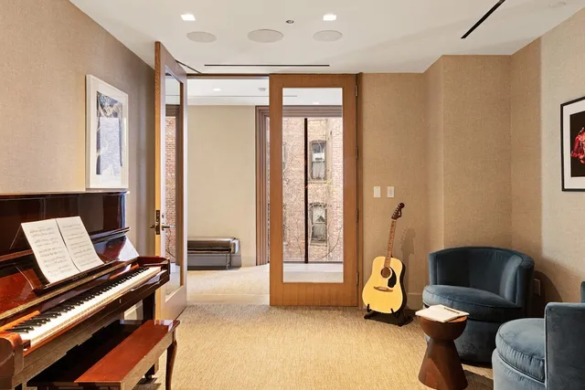 a living room with furniture and a floor to ceiling window