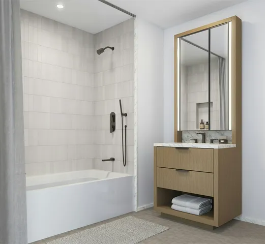 a bathroom with a granite countertop sink a toilet and shower