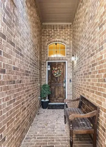 a view of a door with brick walls