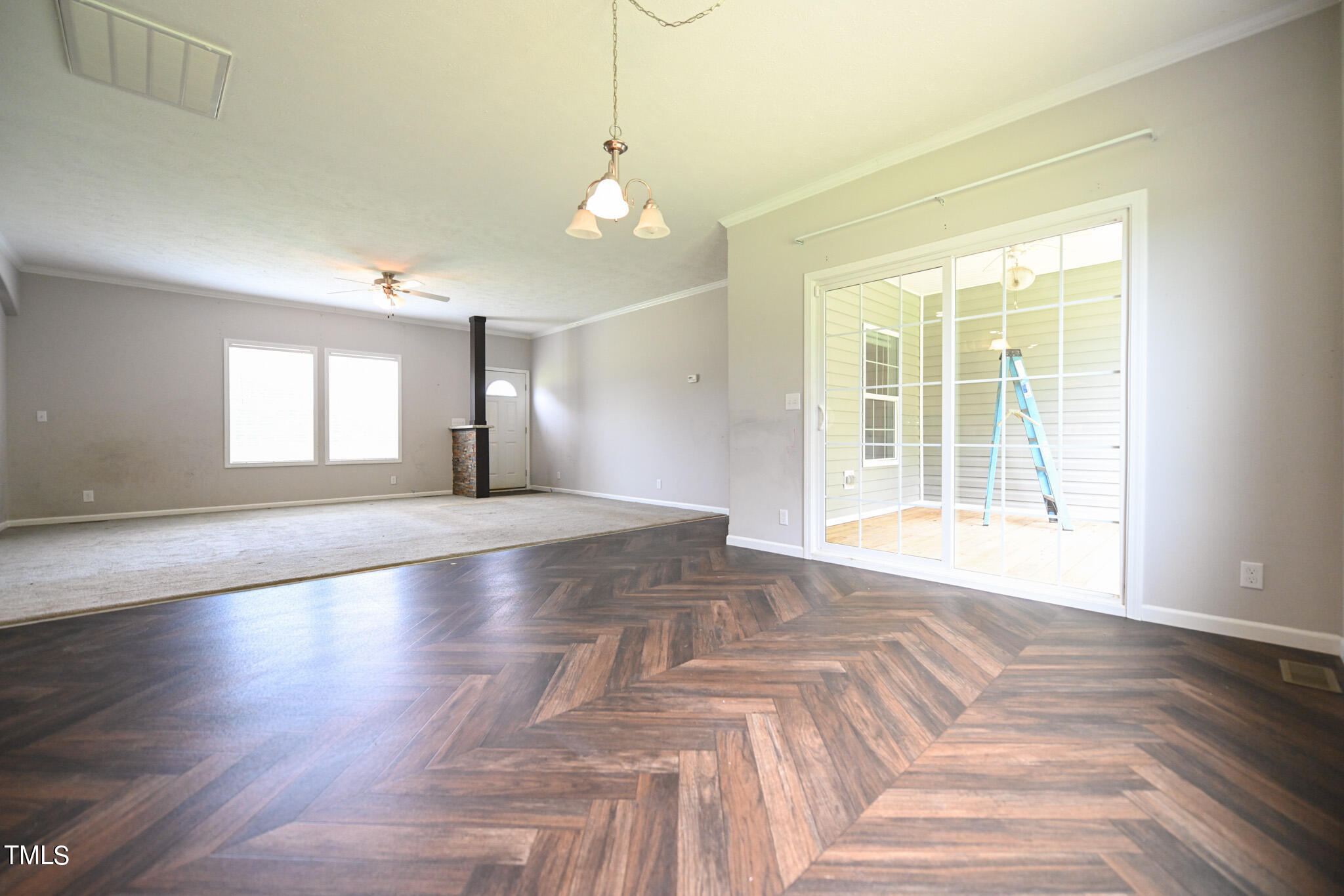 124 Evans Road Princeton, NC 27569 - Photo 11 of 44 a view of an empty room with wooden floor and a window