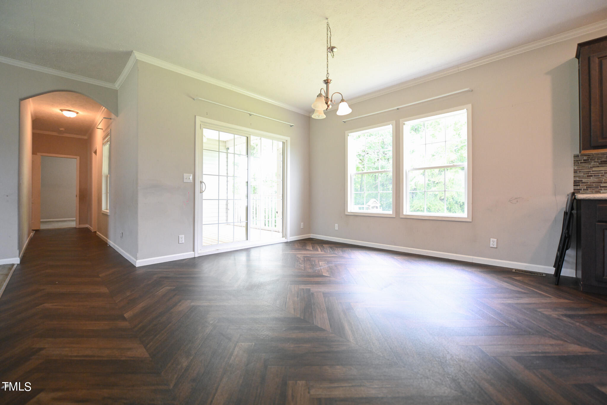 124 Evans Road Princeton, NC 27569 - Photo 12 of 44 a view of an empty room with wooden floor and a window