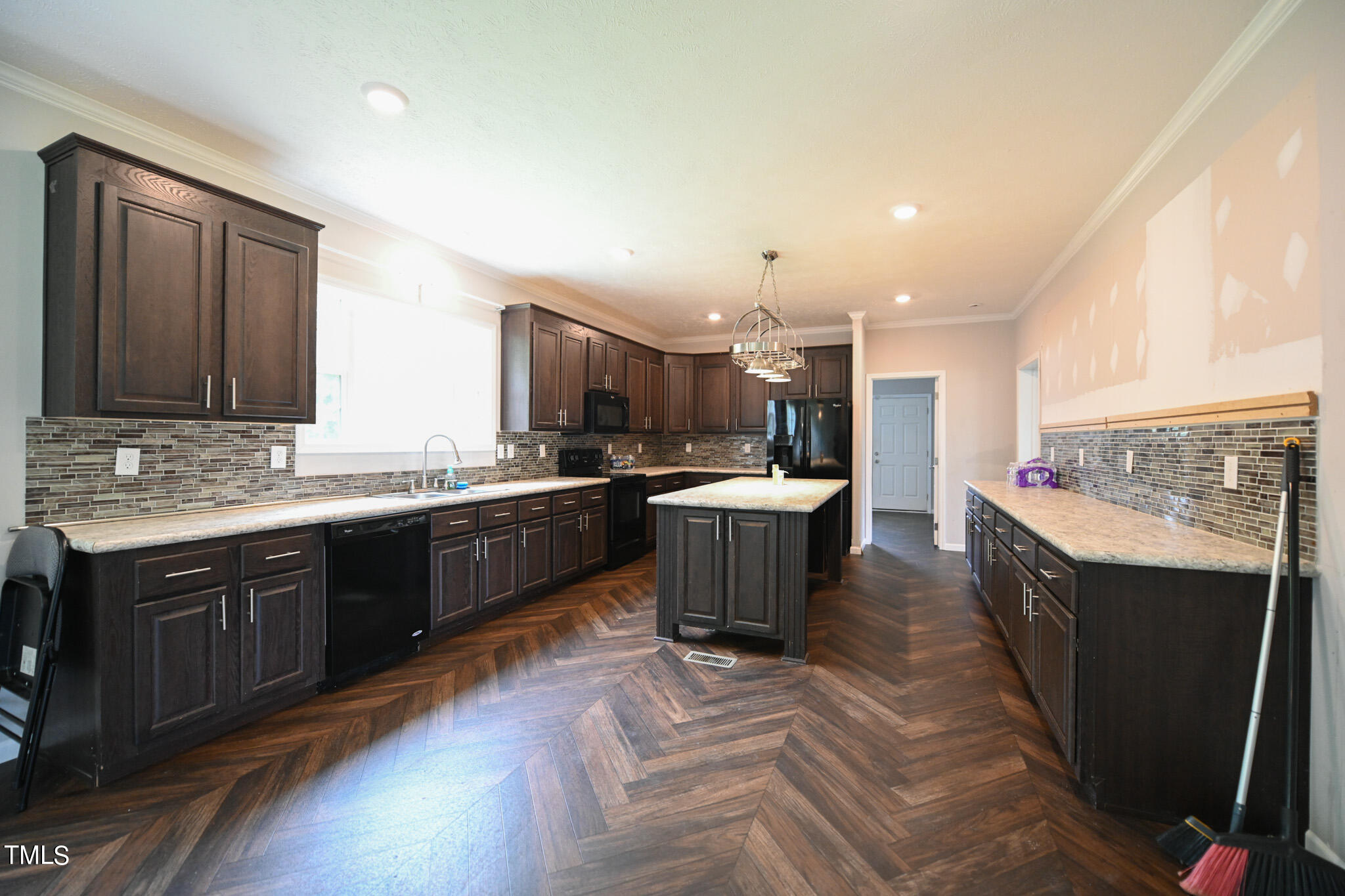 124 Evans Road Princeton, NC 27569 - Photo 13 of 44 a large kitchen with a large counter top a sink stainless steel appliances and cabinets