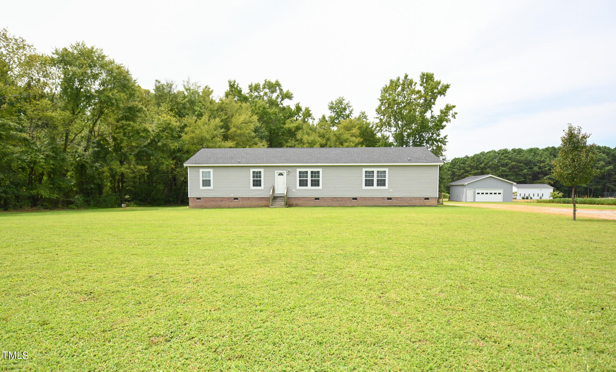 124 Evans Road Princeton, NC 27569 - Photo 2 of 44 a house view with swimming pool in front of it