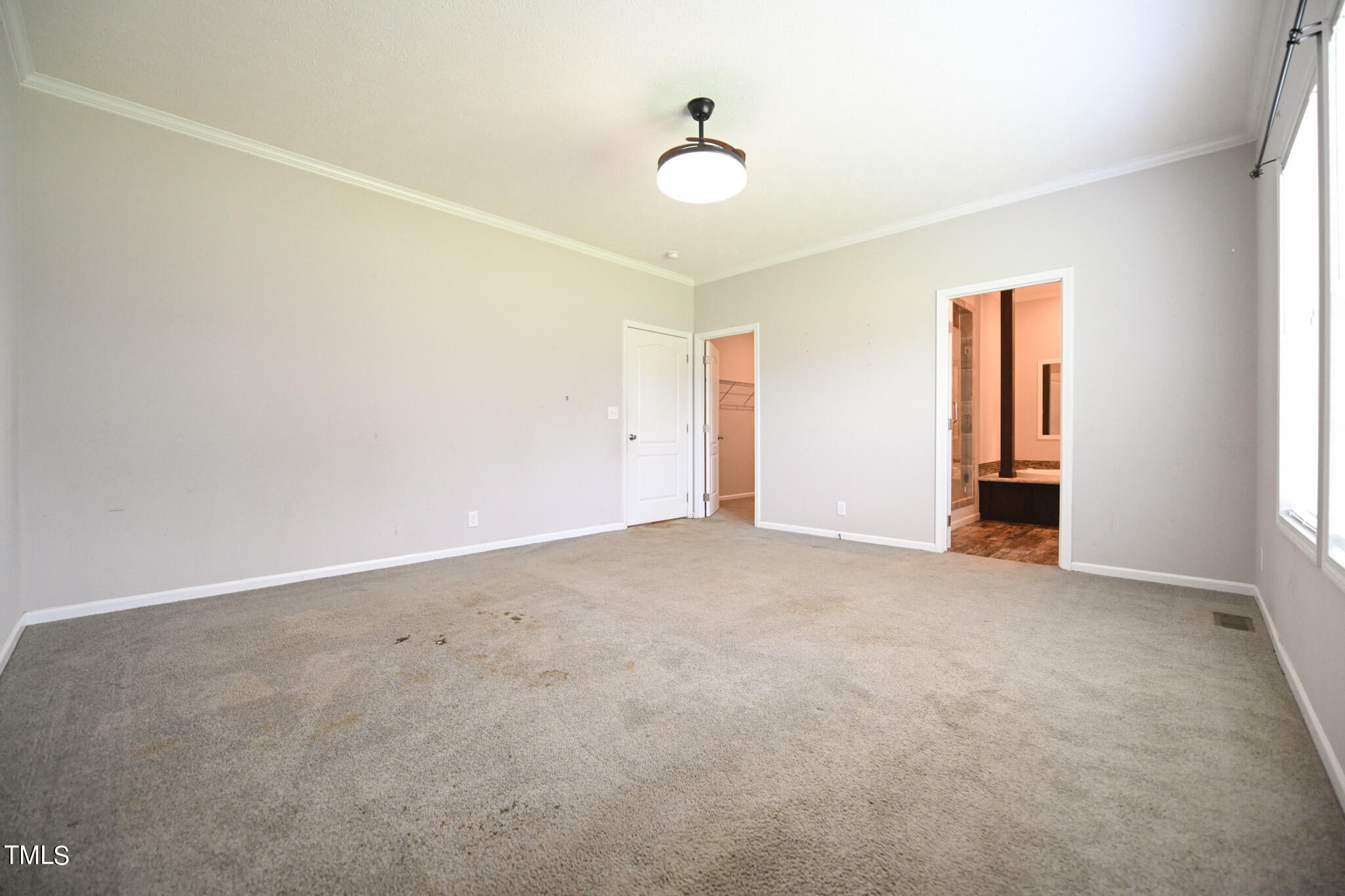 124 Evans Road Princeton, NC 27569 - Photo 22 of 44 an empty room with windows and closet