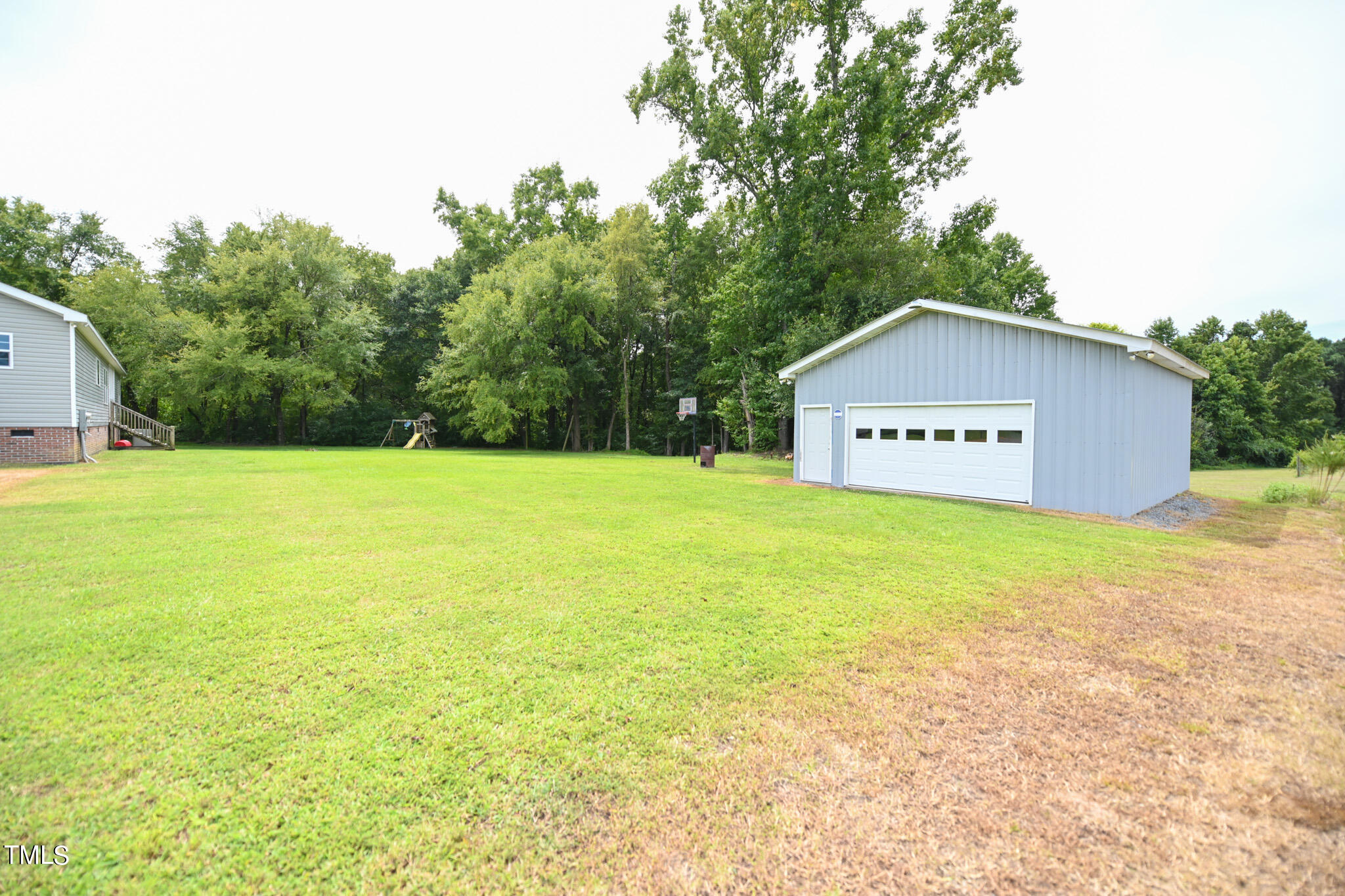 124 Evans Road Princeton, NC 27569 - Photo 40 of 44 a sign that is sitting in the grass with trees in the background