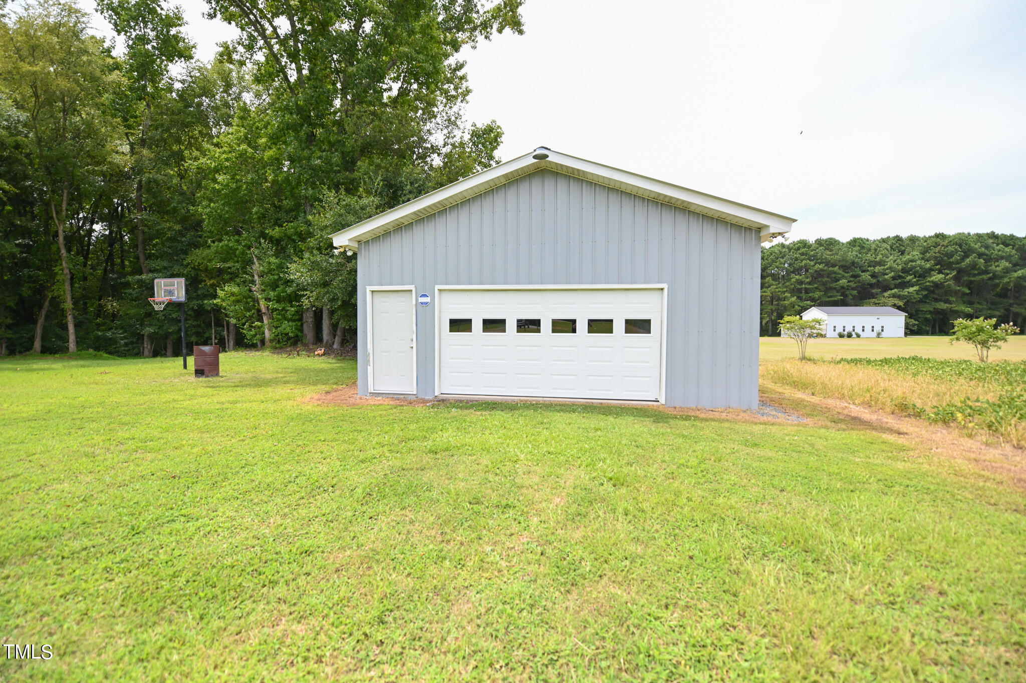 124 Evans Road Princeton, NC 27569 - Photo 41 of 44 a view of a house with backyard and a tree