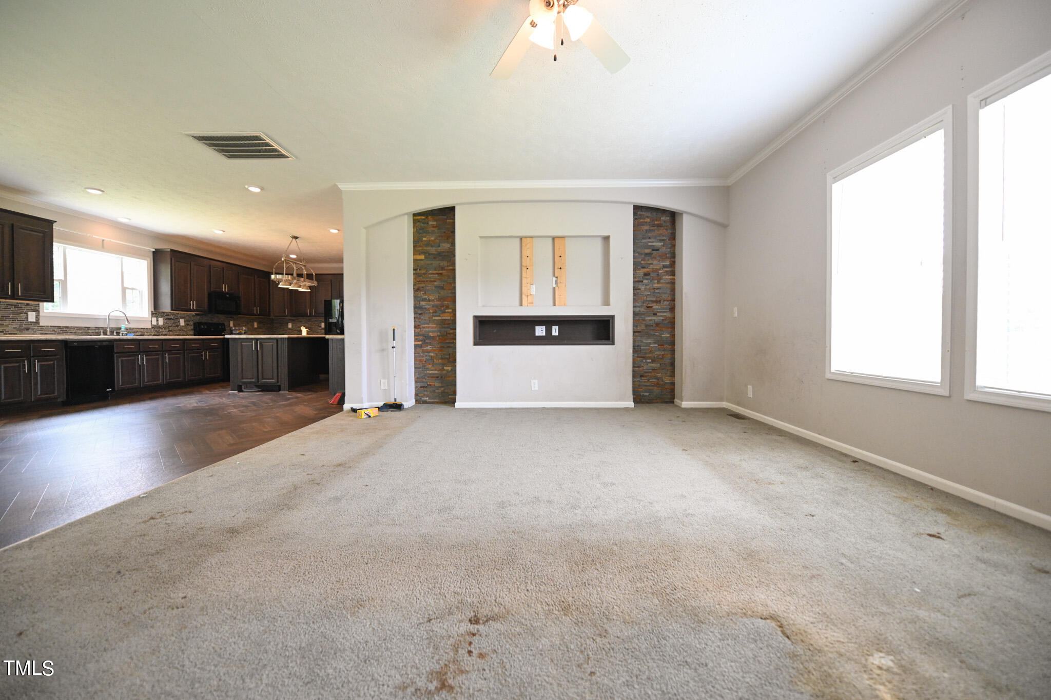 124 Evans Road Princeton, NC 27569 - Photo 5 of 44 an empty room with a kitchen and windows