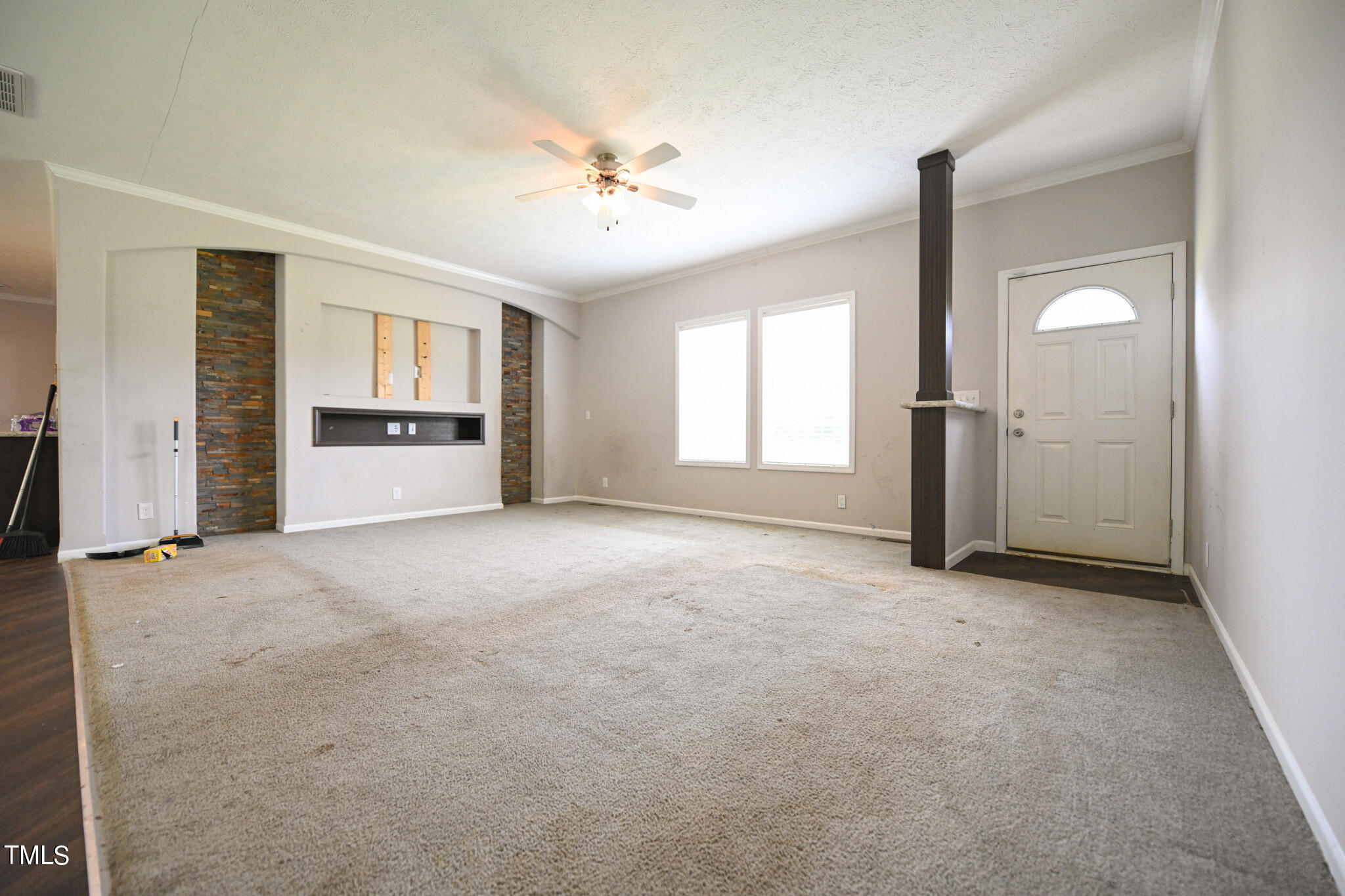 124 Evans Road Princeton, NC 27569 - Photo 6 of 44 an empty room with windows and cabinet