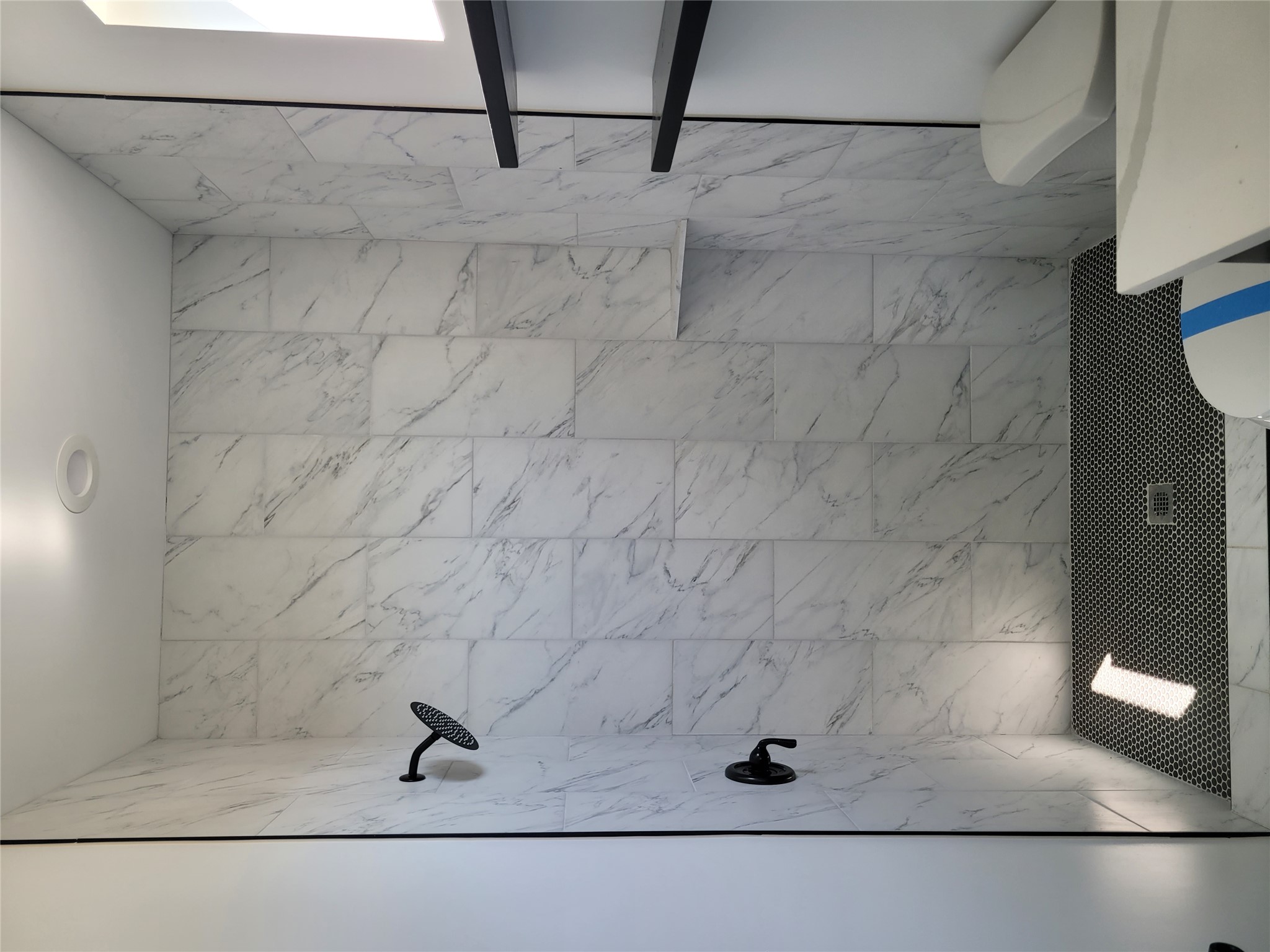 422 County Road 422 Road Stockdale, TX 78160 - Photo 22 of 37 A well-appointed shower space showcases sleek marble-look tile walls and a contrasting hexagonal floor.